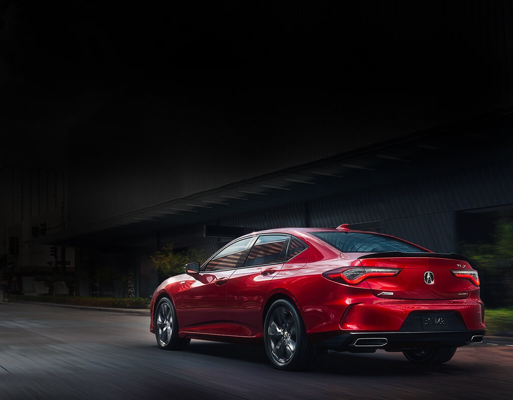 2023 Red Acura TLX Sedan Viewed from Rear on Road